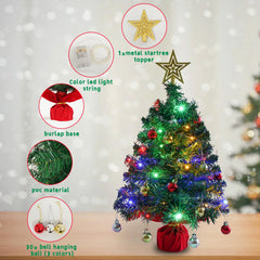Red ornaments and blue tinsel on mini tabletop Christmas tree