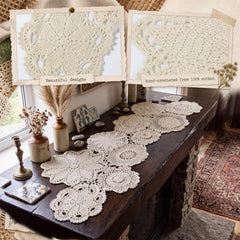 40 inch beige crochet lace table runner on wooden surface