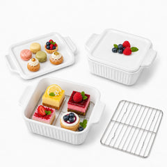 Two 7-inch square ceramic baking dishes with lids and racks