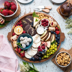 Large round wood serving platter with raised rim