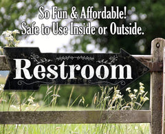 Restroom directional sign with two screw holes for mounting