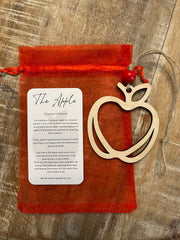 Apple ornament includes red bead and juke twine string