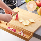 Bamboo cutting board with built in waste container