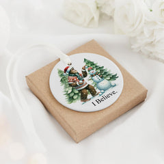 Snow-dusted pine trees scene on white ceramic ornament