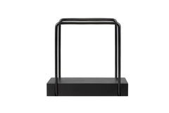 Black metal napkin holder on tabletop with bamboo base