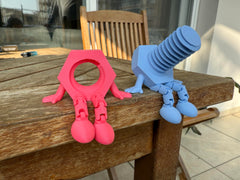 Bolt and nut figurine with articulated legs close up