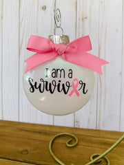 Shatterproof plastic ornament White with pink ribbon glitter inside and hanging hook