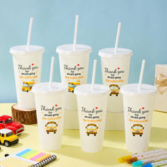 Cup featuring cartoon school bus pattern and star decorations on white cup