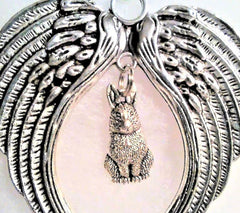 Antiqued metal angel wings ornament with satin cord hanging display