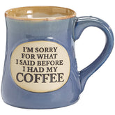 Burton & Burton coffee mug teal with tan trim and front oval medallion inscription