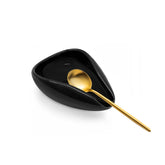 Ceramic coffee spoon rest in small black on kitchen counter