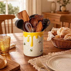 Bee themed ceramic utensil holder used as kitchen decor