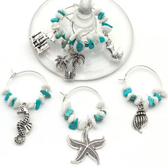 Coastal beach themed wine glass charms featuring seashell starfish palm tree mermaid motifs