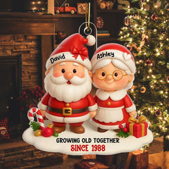 Durable clear acrylic Santa and Mrs Claus ornament with red ribbon