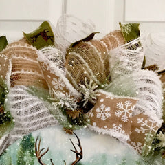 Metal deer sign on snowdrift deco mesh center of wreath