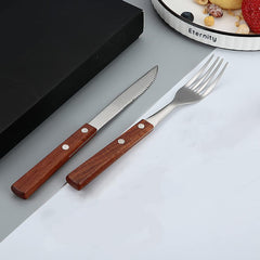 Two forks and two knives laid out for dining at home