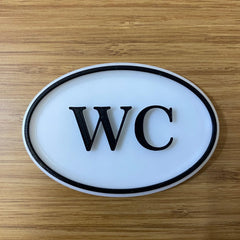 White and black toilet plaque for home or business use
