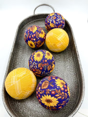 Blue fabric wrapped sunflower balls used as fall decor bowl filler