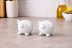 Farmhouse style white ceramic pig salt and pepper shakers compact size on table