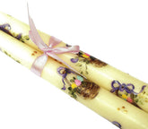 Close up of hand painted candle with lavender bow
