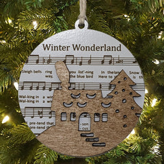 Handcrafted USA Made two-layer wood ornament featuring cottage scene and hymn sheet music