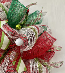 Center ring with metallic red and metallic green ribbons on wreath