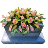 Headstone Flower Saddle with silk flowers on a grave marker
