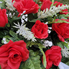 Headstone topper secured with protective rubber coverings on saddle legs