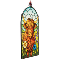HighlandCow holiday ornament displayed on tree and window