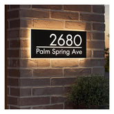 Illuminated house number sign close up showing customization options