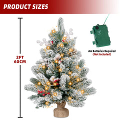 Snow flocked mini tree with berry clusters and pinecones