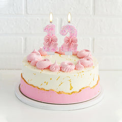 Two-pack pink bow birthday candles for cake decorating