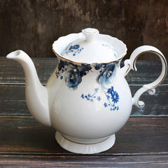 Hand painted porcelain teapot with flower motif and gold trim