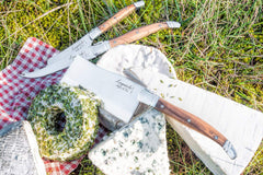 Close up olive wood handle on Laguiole Style De Vie cheese knife