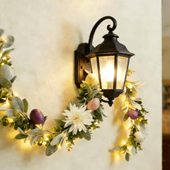Close up of daisies on Easter garland with pastel eggs