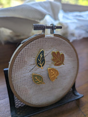 Needle minder with two magnets for holding needle down