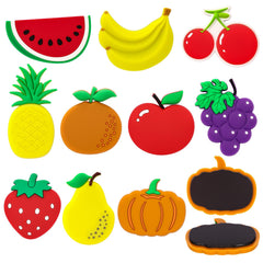 Assorted fruit magnets on fridge surface