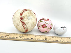 Decorative rag balls displayed in a tray or vase