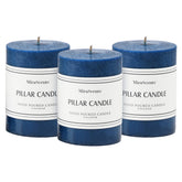 Three navy blue 3x4 inch unscented pillar candles in a 3-pack