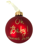 Red glass ball pregnancy announcement ornament for Oh Baby Coming 2026