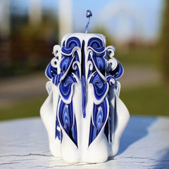 Blue carved candle with purple edge petals by Oscar Candles