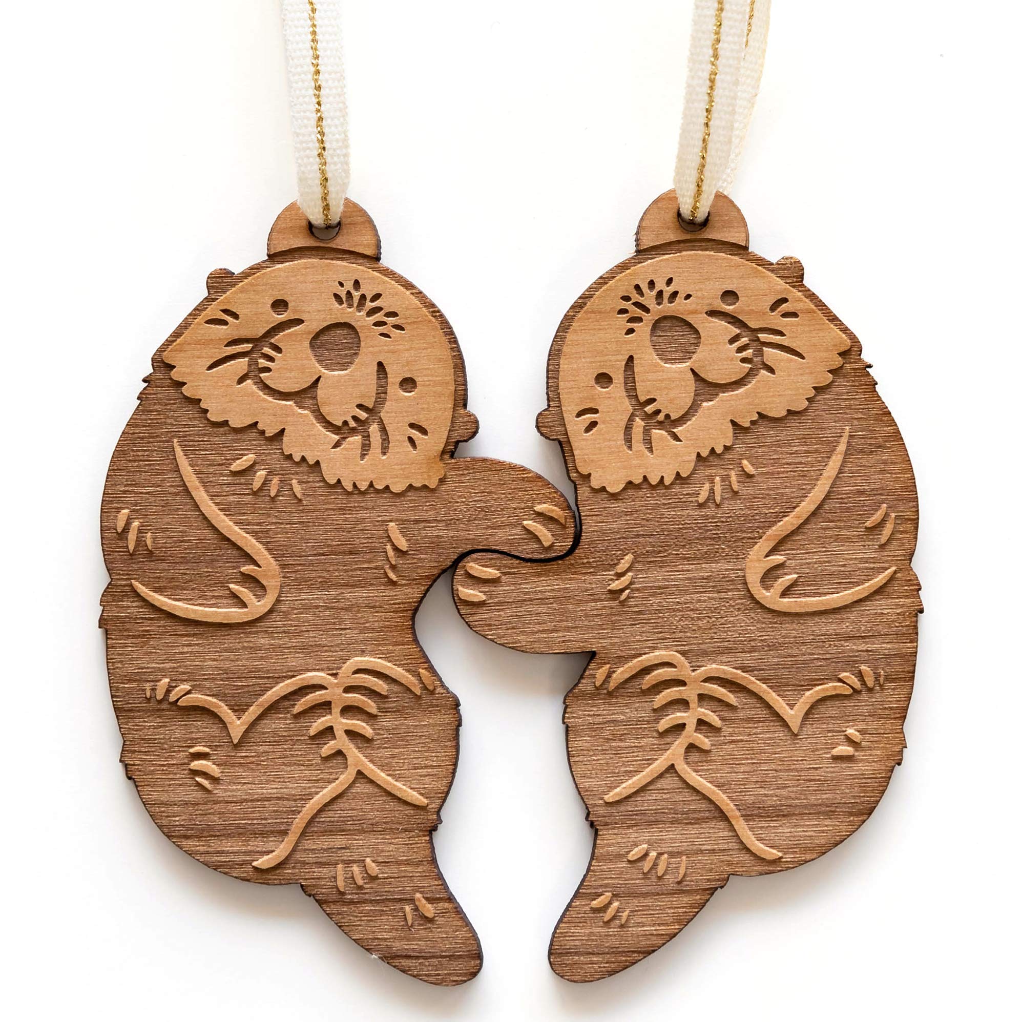 Otters hand-holding design on wood ornament pair