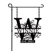 Personalized garden flag outside with last name sign