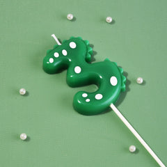 Green dinosaur number candle with holder for cake surface