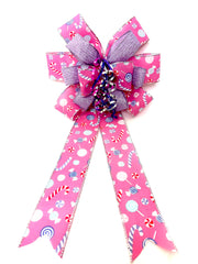 Pink Whimsy Candy Bow attached to wreath on door