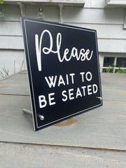 Laser engraved acrylic sign with stainless steel hardware for counter display