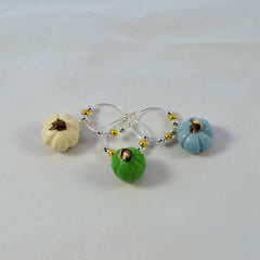 Assorted colors pumpkin themed wine glass charms made of polymer clay