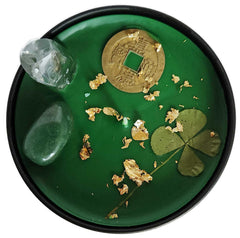 Clover and feng shui coin accent on candle