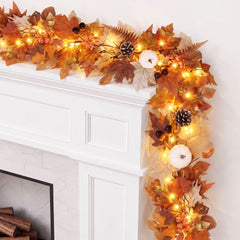 autumn display garland shows maple leaves berries pumpkins