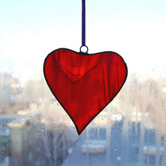 Red heart stained glass artwork showing color variations in light